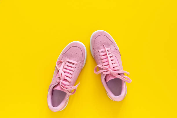 istock Pink sneakers isolated on a yellow background 1220435646