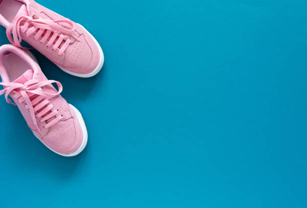 istock Pink sneakers isolated on a turquoise blue background 1220435650