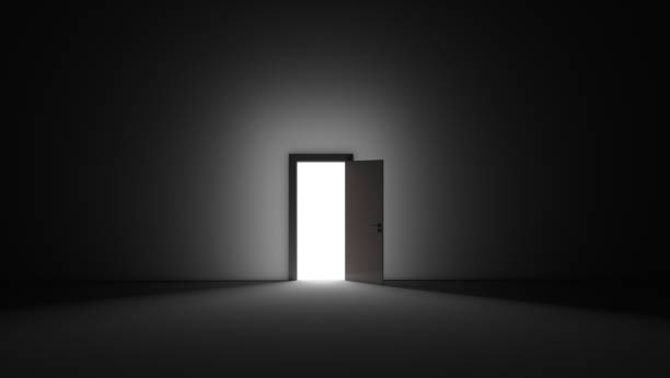 istock An open door with bright light streaming into a very dark room. 3D rendering illustration 1220436504