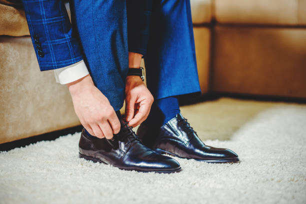 istock An elegant man puts on black, leather, formal shoes. 1220436550