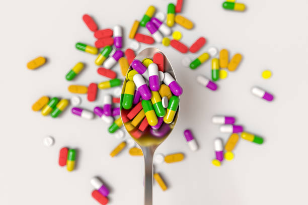 istock Assorted pharmaceutical medicine pills and tablets spoon. 3D rendering illustration 1220436805