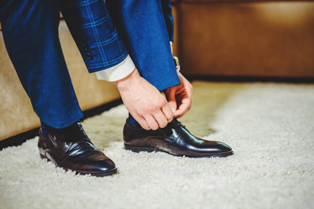 istock An elegant man puts on black, leather, formal shoes. 1220436948