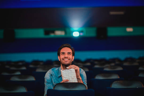 istock Young man watching a movie 1220437975