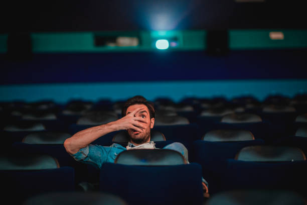 istock Young man watching a movie 1220438039