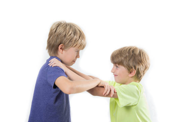 istock Two kids fighting, siblings, friends fight isolated on a white background 1220438062