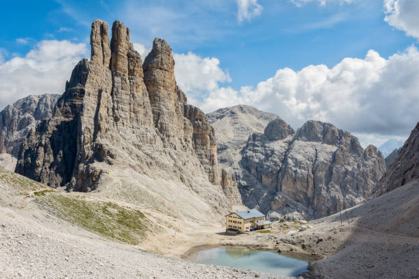 Rifugio Re Alberto and the Vajolet Towers (Torri Vajolet), Dolomites, Italy on a beautiful summer day Rifugio Re Alberto and the Vajolet Towers (Torri Vajolet), Dolomites, Italy on a beautiful summer day with scattered clouds catinaccio stock pictures, royalty-free photos & images