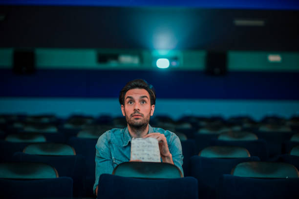 istock Young man watching a movie 1220439201