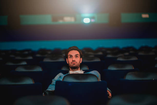 istock Young man watching a movie 1220439225