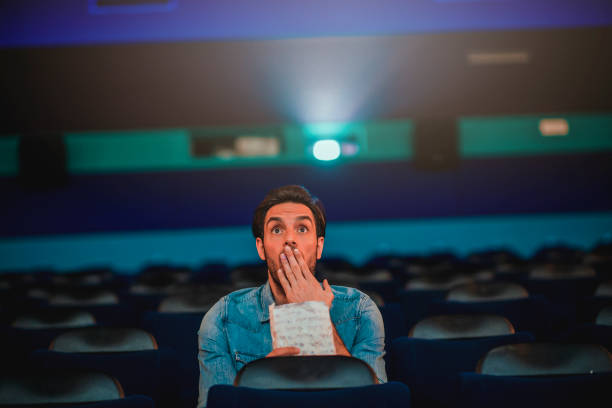istock Young man watching a movie 1220439270