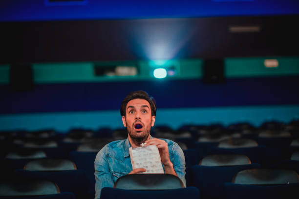 istock Young man watching a movie 1220439293