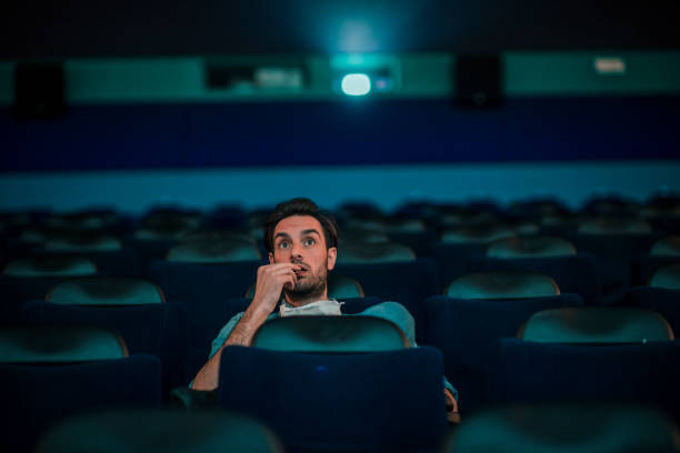 istock Young man watching a movie 1220439317