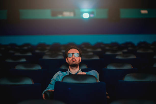 istock Young man watching a movie 1220439361