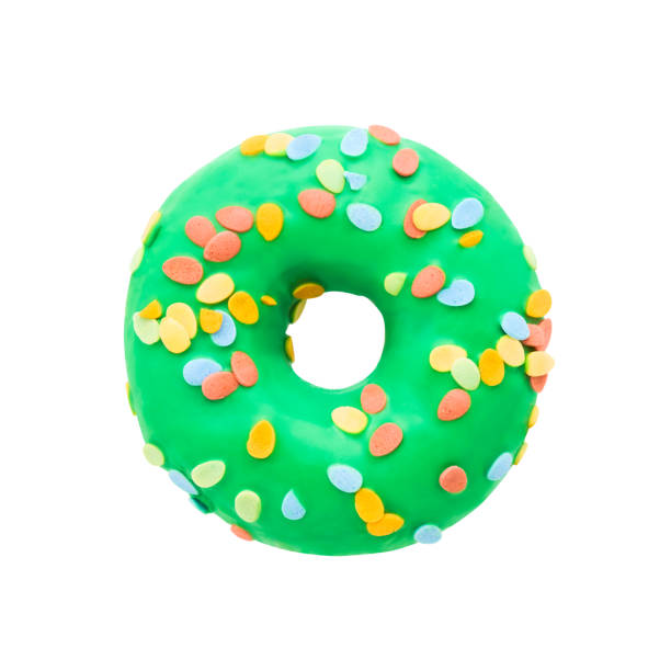 istock Green donut with sprinkles isolated on white background 1220440399