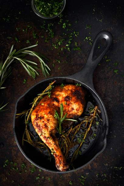 istock Chicken leg in a skillet 1220440515