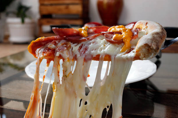 istock Serving slice of pepperoni pizza with melting mozzarella 1220440727