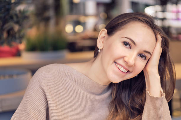 istock Girl smiles at the camera in a cafe. 1220441462