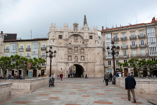 Pedestrians walk near the Puerta de Santa María, an ornate entrance into the old town of Burgos, Spain. June 11, 2018