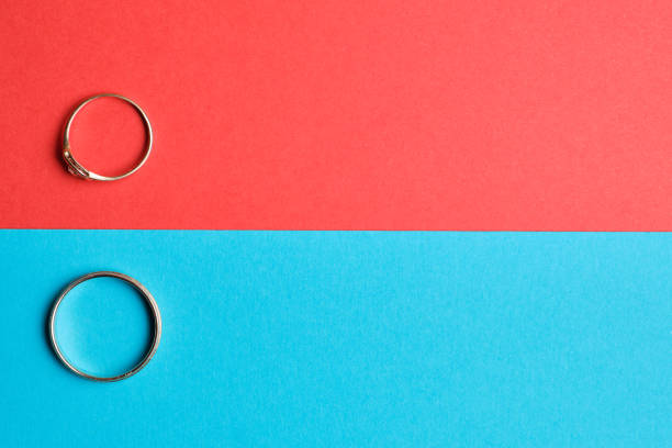 istock Wedding rings on a red and blue background. Top view. Copy space. 1220442545