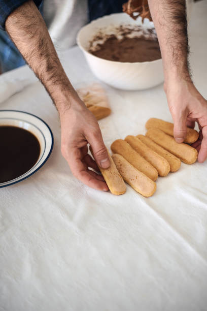 istock Quarantine cooking: a man cooks a tiramisu using an electric mixer, chocolate, biscuits and coffee 1220442765