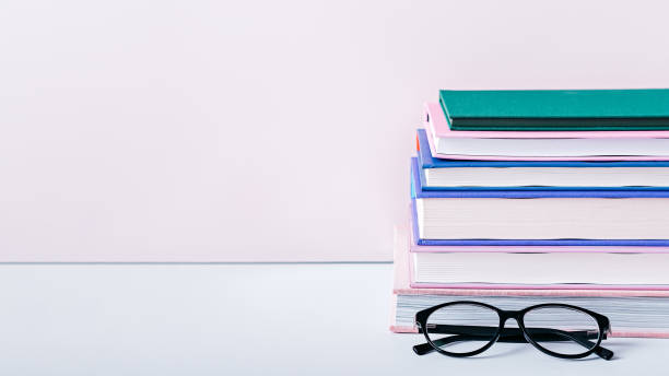 istock Home interior with books stack, eyeglasses, house plants succulents and fragrant candle and sticks. Still life with black board for text, stack of colorful books and home interior decor 1220442965