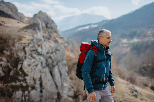 istock Male hiker in the mountains with backpack 1220443105
