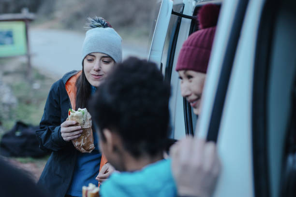 istock Group of climbers eating during rest from extreme rock climbing 1220443947