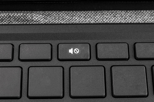 sign without sound silence on the keyboard keys of a laptop or personal computer, the concept of observing silence and noise pollution