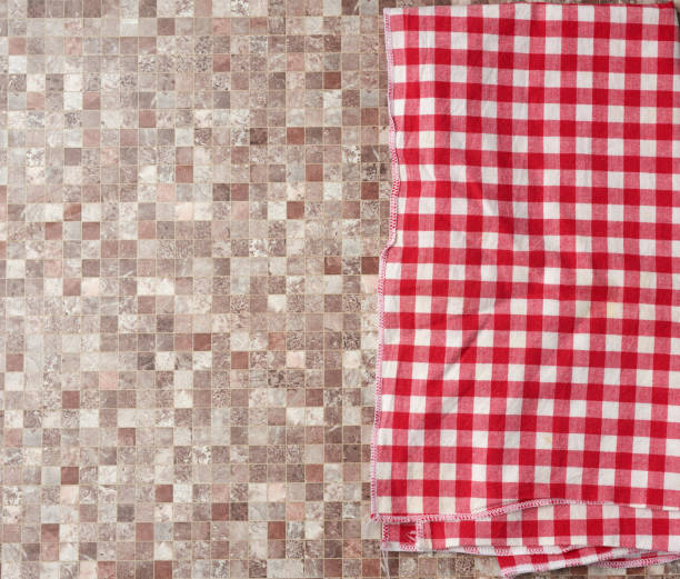 istock red checked cotton kitchen towel on a brown kitchen surface, top view 1220448144