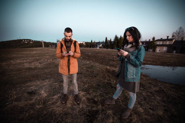 istock Couple walking and taking selfies 1220448215