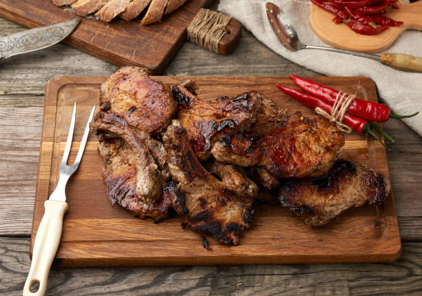 istock grilled pork steaks on the bone on a kitchen cutting board 1220448335