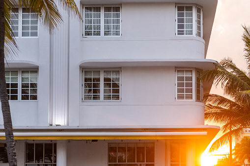 This is a photograph of an Art Deco building exterior at sunset in South Beach, Miami, Florida.