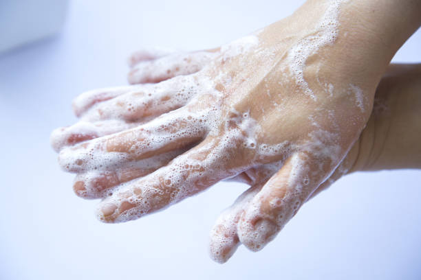 istock Unrecognizable Person washing her hands with soap bubbles 1220450320