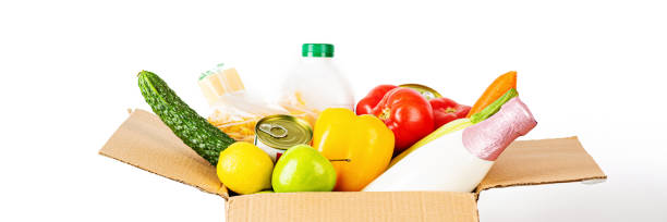 istock Donation box with various food isolated on white background with copy space. Mockup, web banner. Food donations or food delivery service concept. Online shopping during coronavirus covid-19 lockdown 1220453050