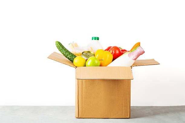 istock Donation box with various smart food on white background with copy space. Mockup. Food donations or food delivery service concept. Online shopping during coronavirus covid-19 lockdown 1220453181
