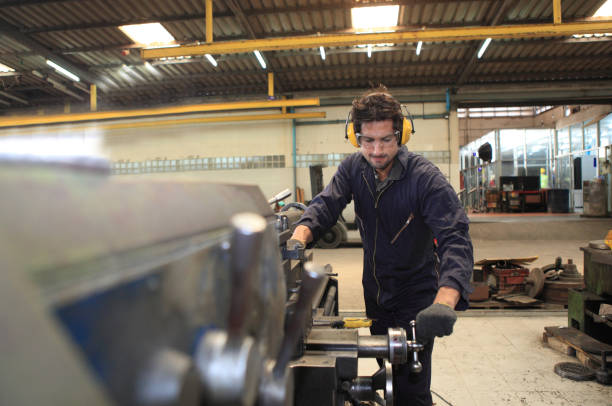 istock Male  Industrial Engineers with  machine. Assist production engineer in industry. He checking and  control flow of process in production. Concept Successful of Work. 1220455146