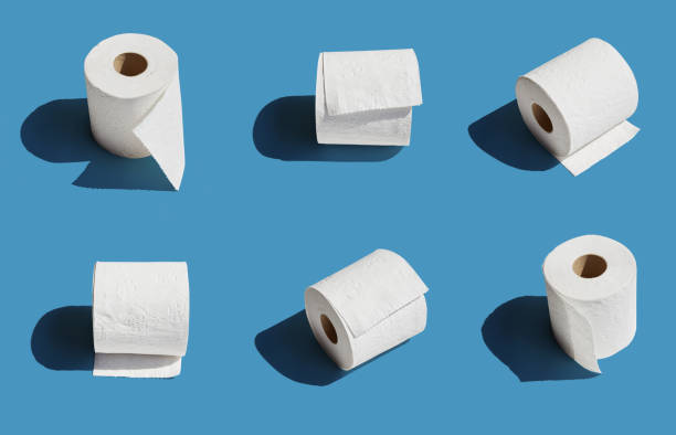 istock White toilet paper roll on blue background with shadow 1220455261