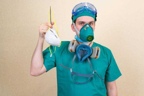 istock Doctor holds respirator mask 1220455447