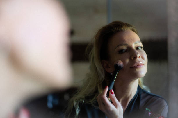 istock Adult woman applying makeup 1220456095