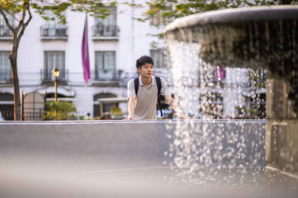 istock Teenage boy looking at fountain 1220457014