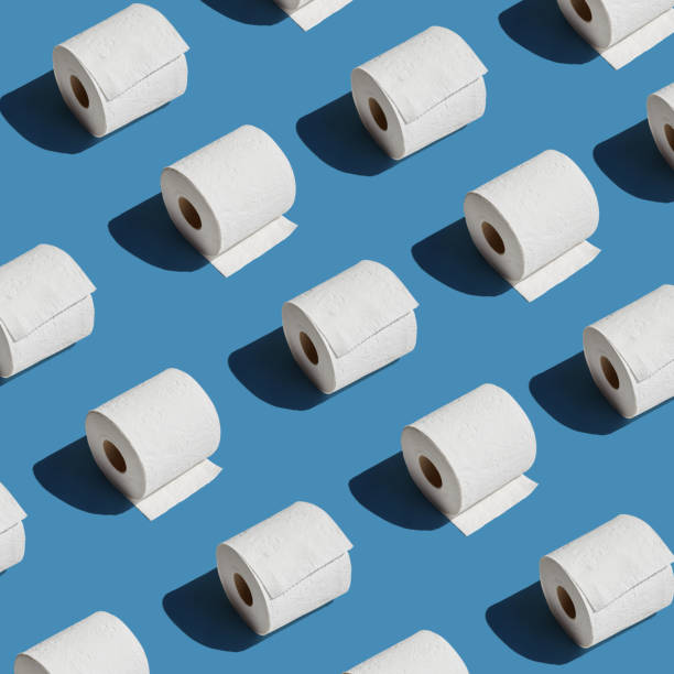 istock White toilet paper roll on blue background with shadow 1220457024