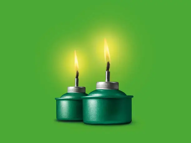 Ramadan oil lamp or Muslim tradition oil lamp glowing on green background