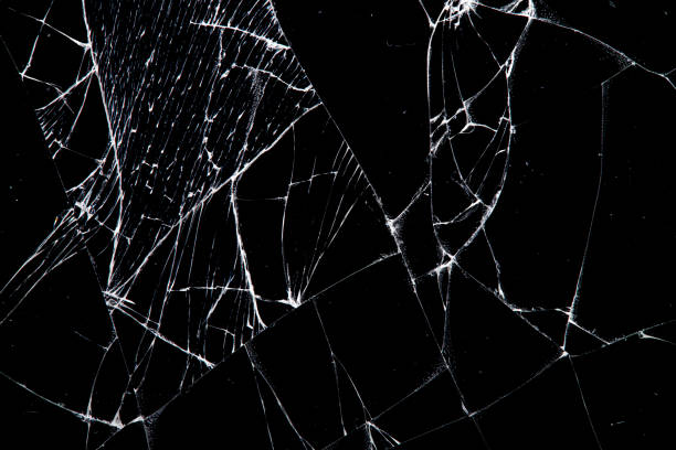 istock cracked glass isolated on a black background. 1220457692