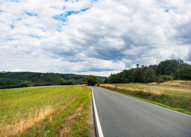 istock Asphalt road and green fields in Czech Republic 1220458973