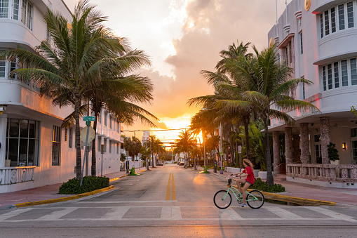 In Miami Beach, United States one person rides along Ocean Drive in South Beach as the sunsets during the Coronavirus pandemic.