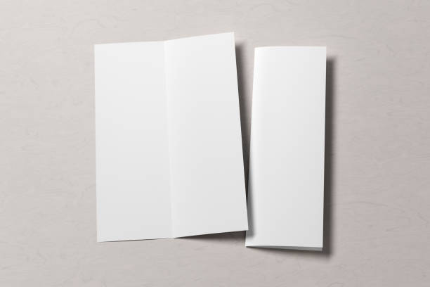 istock Blank bi-fold vertical A4 leaflet cover. Bi-fold or half-fold opened and folded brochure isolated with clipping path. 1220459717