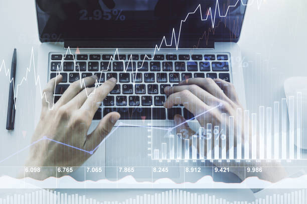 istock Double exposure of abstract creative financial chart with hand typing on computer keyboard on background, research and strategy concept 1220459959