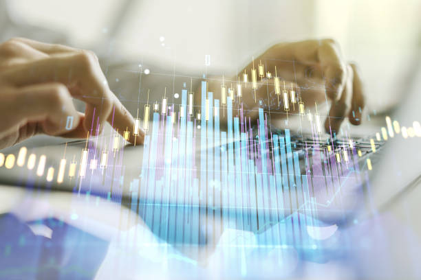 istock Abstract creative financial graph with hand typing on laptop on background, financial and trading concept. Multiexposure 1220460053