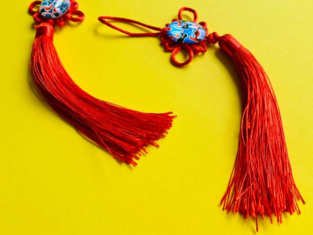 istock Red Chinese knots for good luck on yellow background with copy space. 1220466587