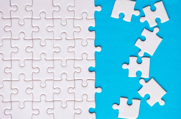 istock Jigsaw puzzle white color,Puzzles pieces grid,Success mosaic solution template,Horizontal on blue color background copy space for text,Top view 1220467421