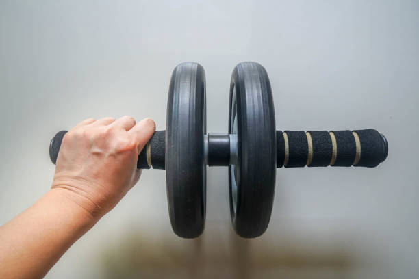 istock close up woman left hand use roller wheel exercise tool for body core strength 1220469056